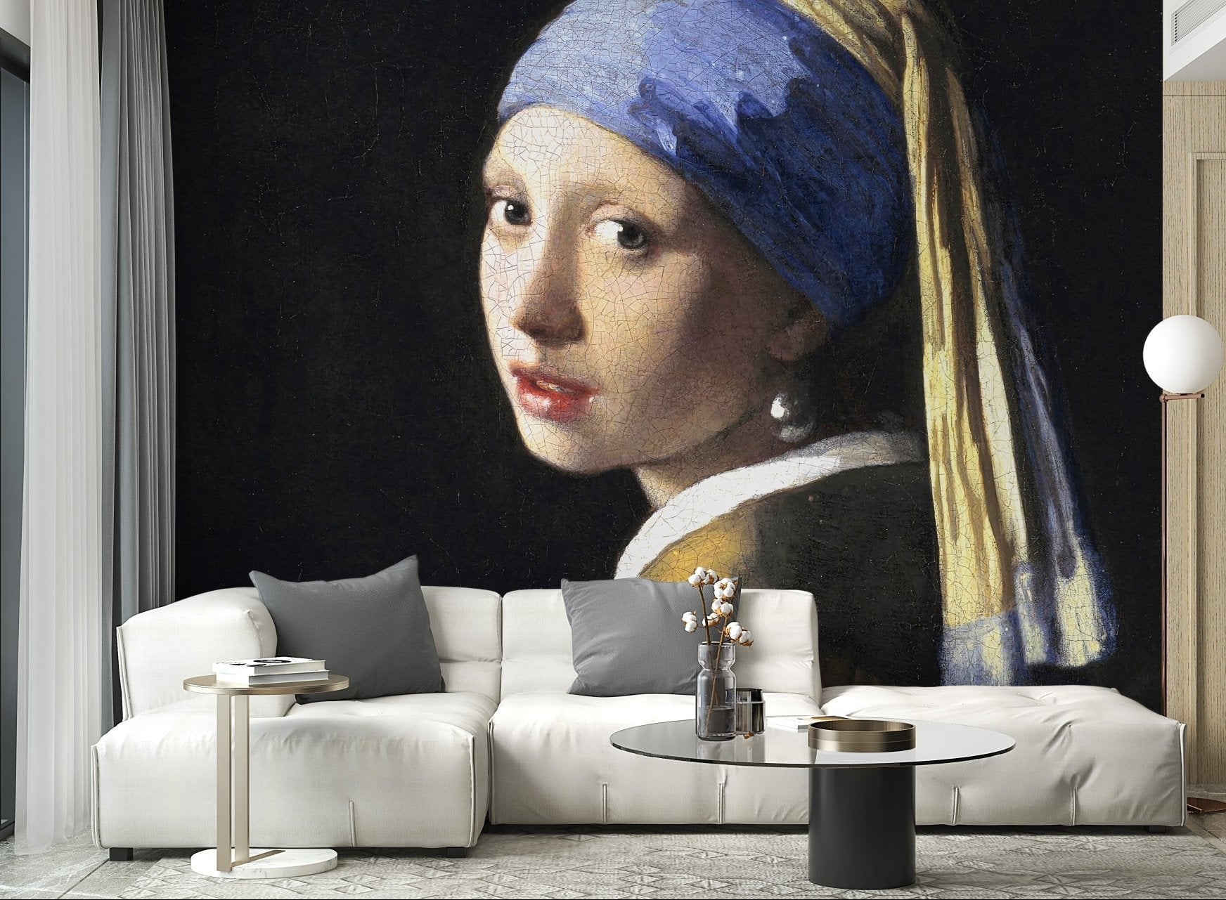 Large scale art mural in a bright living space with a white L-shaped sofa.