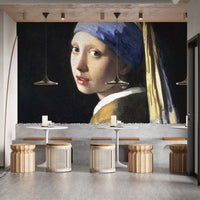 Artistic girl wall mural in a commercial cafe setting with wooden stools and bar.l
