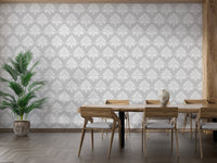 Vintage grey damask wallpaper in a modern dining room with wooden furniture.