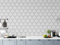 Classic damask wallpaper on a kitchen backsplash wall with blue cabinets.