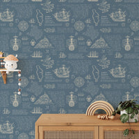 Latin script wall mural behind a wooden desk with small shelf.