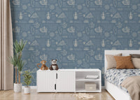 Blue wall mural with manuscript patterns in a bedroom with a white bed