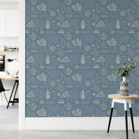 Blue vintage wall mural with white nautical illustrations on a hallway wall