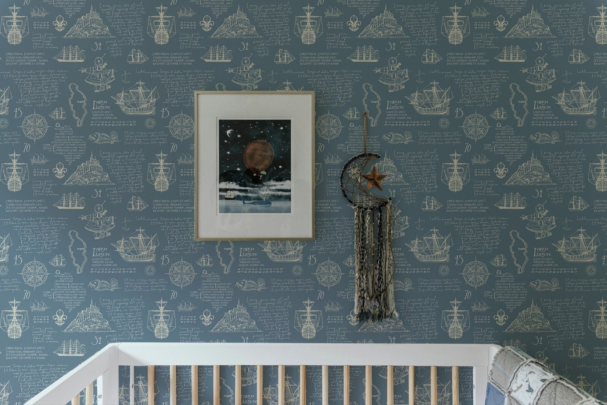Nautical wall mural featuring Latin script and islands behind a white crib