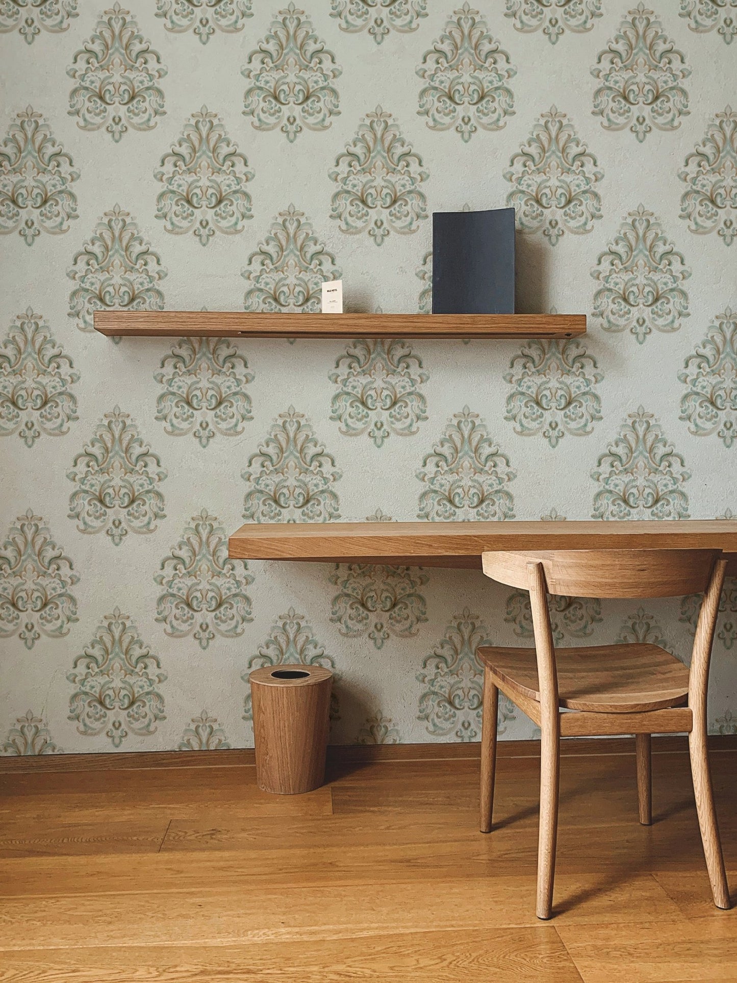 Home workspace featuring a wooden chair and Vintage Milan Damask Green Wallpaper.