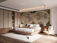 Brown world map wall mural in a minimalist bedroom with a low bed.