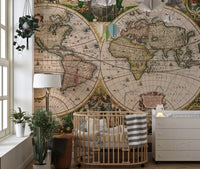 Antique map wall mural behind a wooden crib in a nursery.