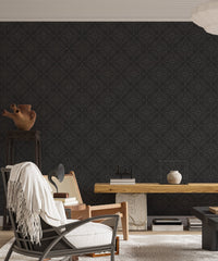 Ornate black wallpaper in a contemporary living area with a marble desk