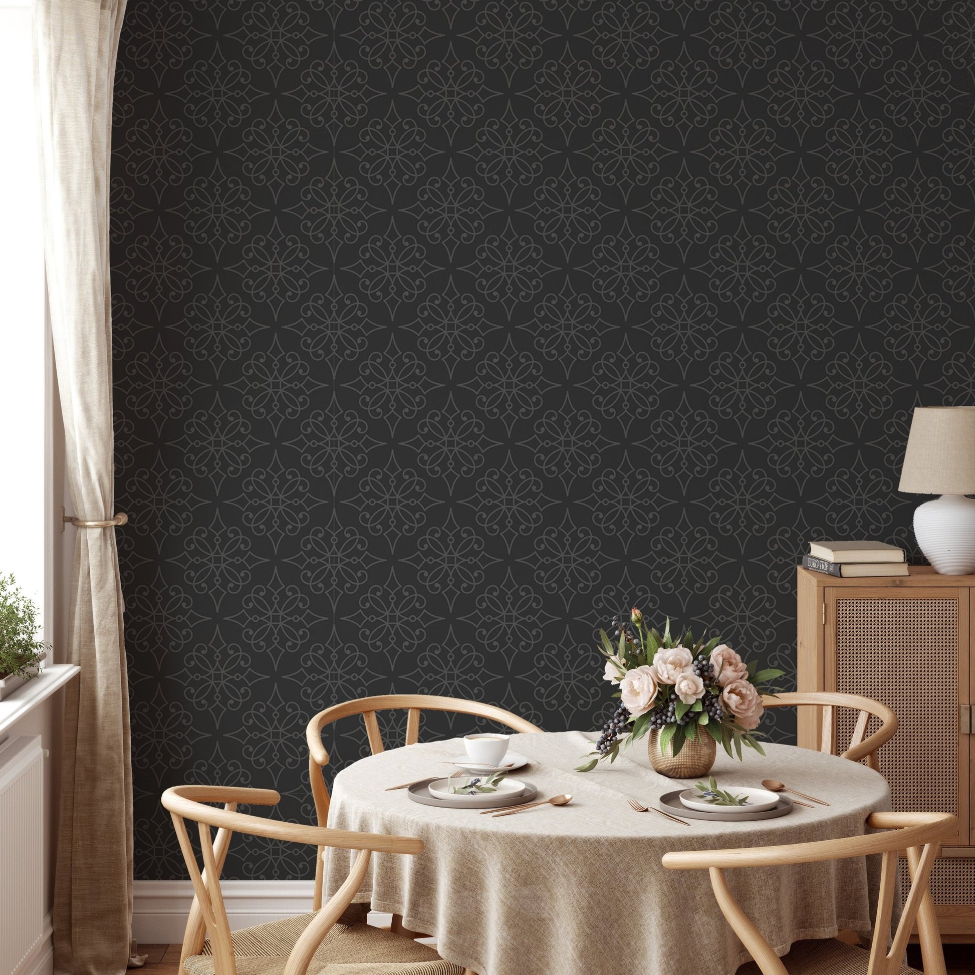 Dark damask wallpaper in a formal dining room with light wood furniture