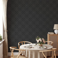 Dark damask wallpaper in a formal dining room with light wood furniture