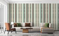 Modern living featuring striped wall mural and an L-shaped sofa with green pillows.