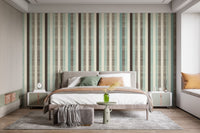 Modern bedroom with striped wall mural and wooden furniture in a neutral palette.