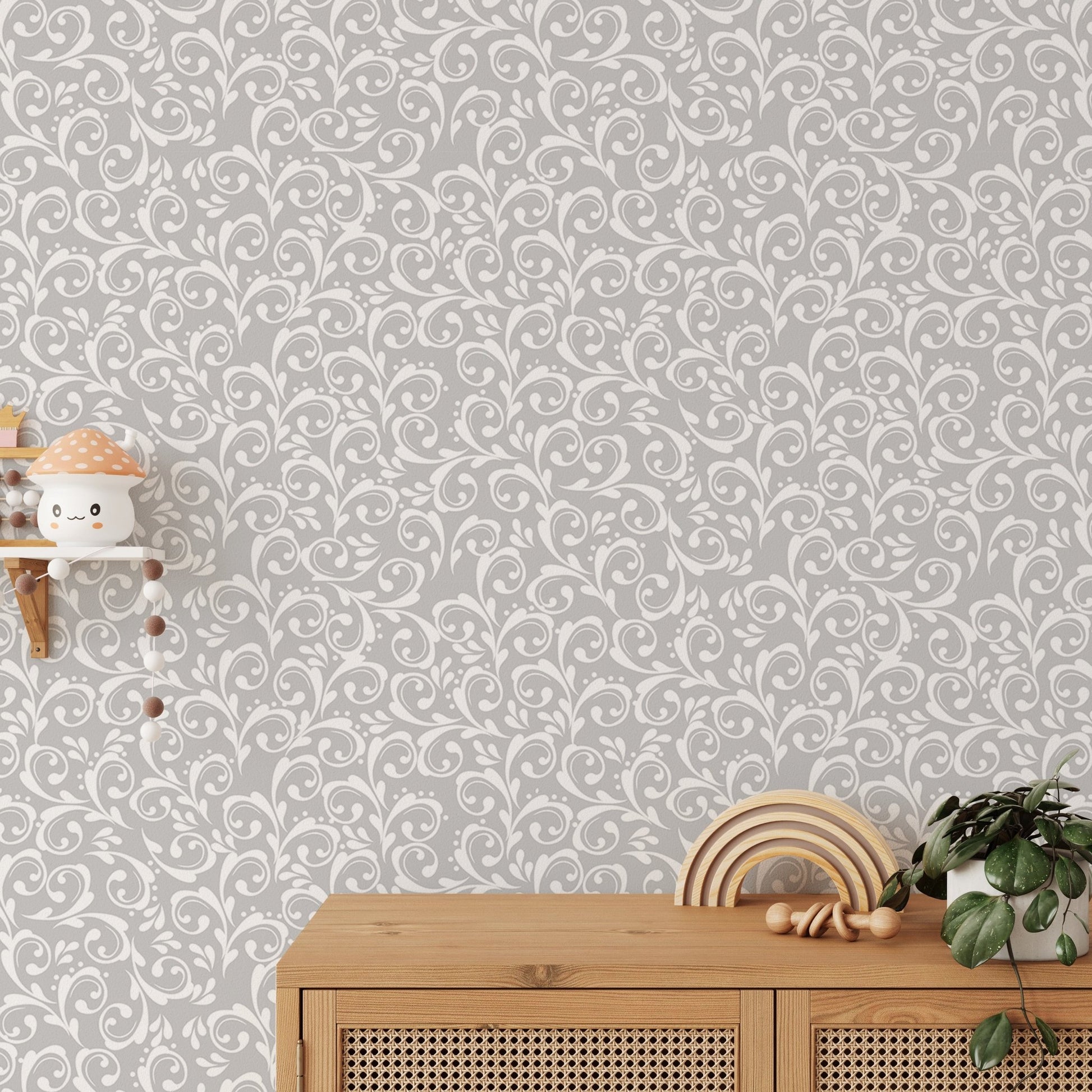 Ornate damask wallpaper pattern behind a wooden sideboard and green plant.