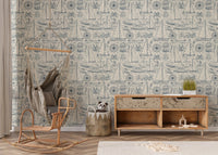 Yachting themed wallpaper in a nursery area with a wooden storage cabinet.