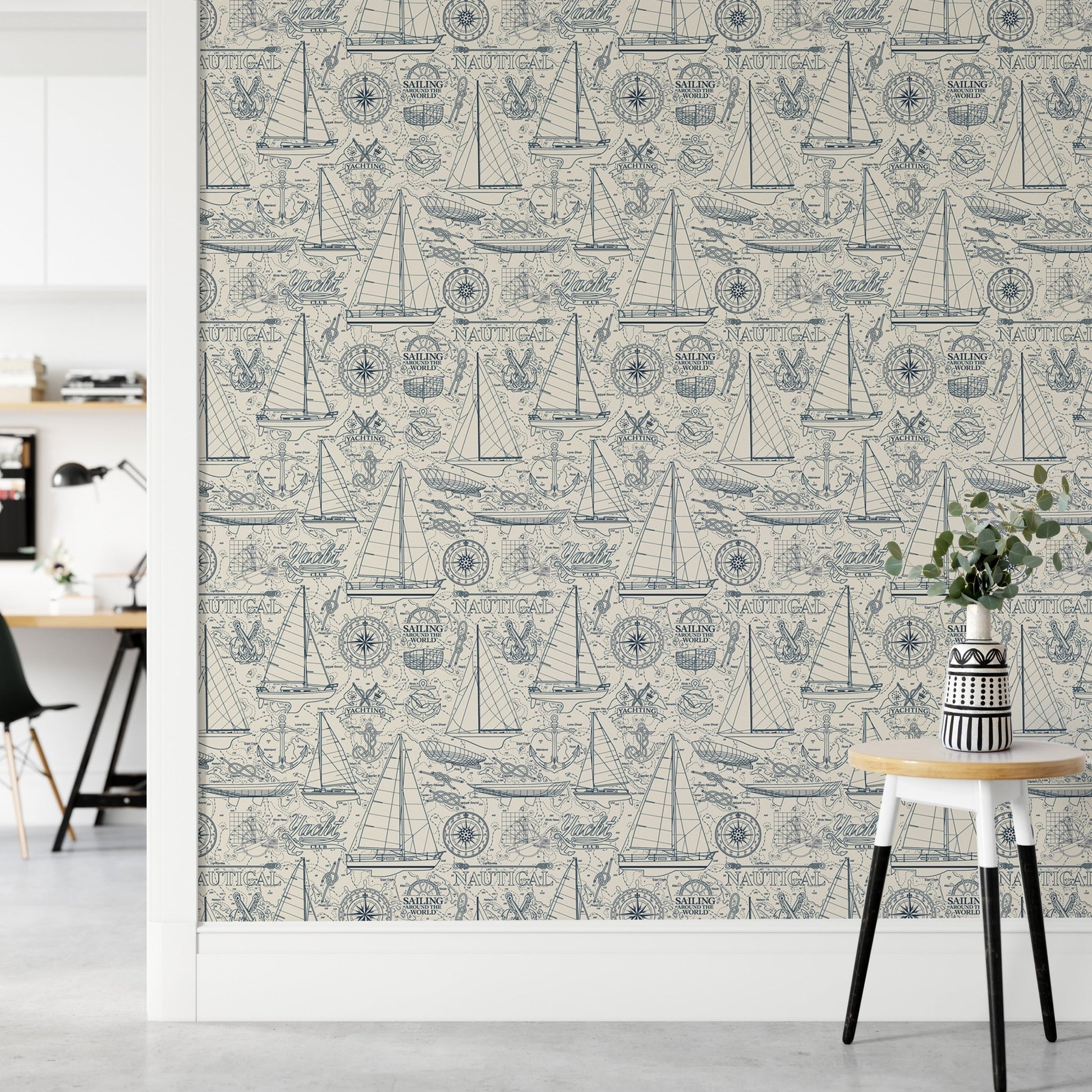 Blue maritime pattern wallpaper in a bright hallway with a white desk.