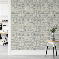 Blue maritime pattern wallpaper in a bright hallway with a white desk.