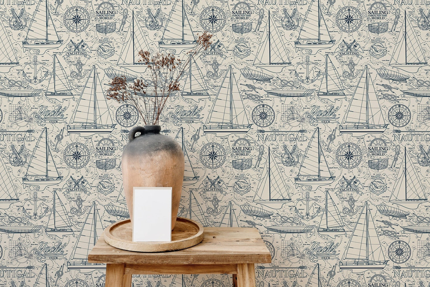 Vintage sailboat wallpaper behind a wooden side table with a ceramic vase.