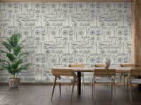 Vintage sailboat wallpaper behind a wooden dining table and chairs.