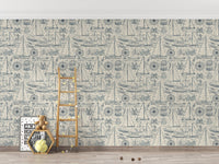 Coastal yachting elements wallpaper in a minimalist playroom with a wooden ladder.