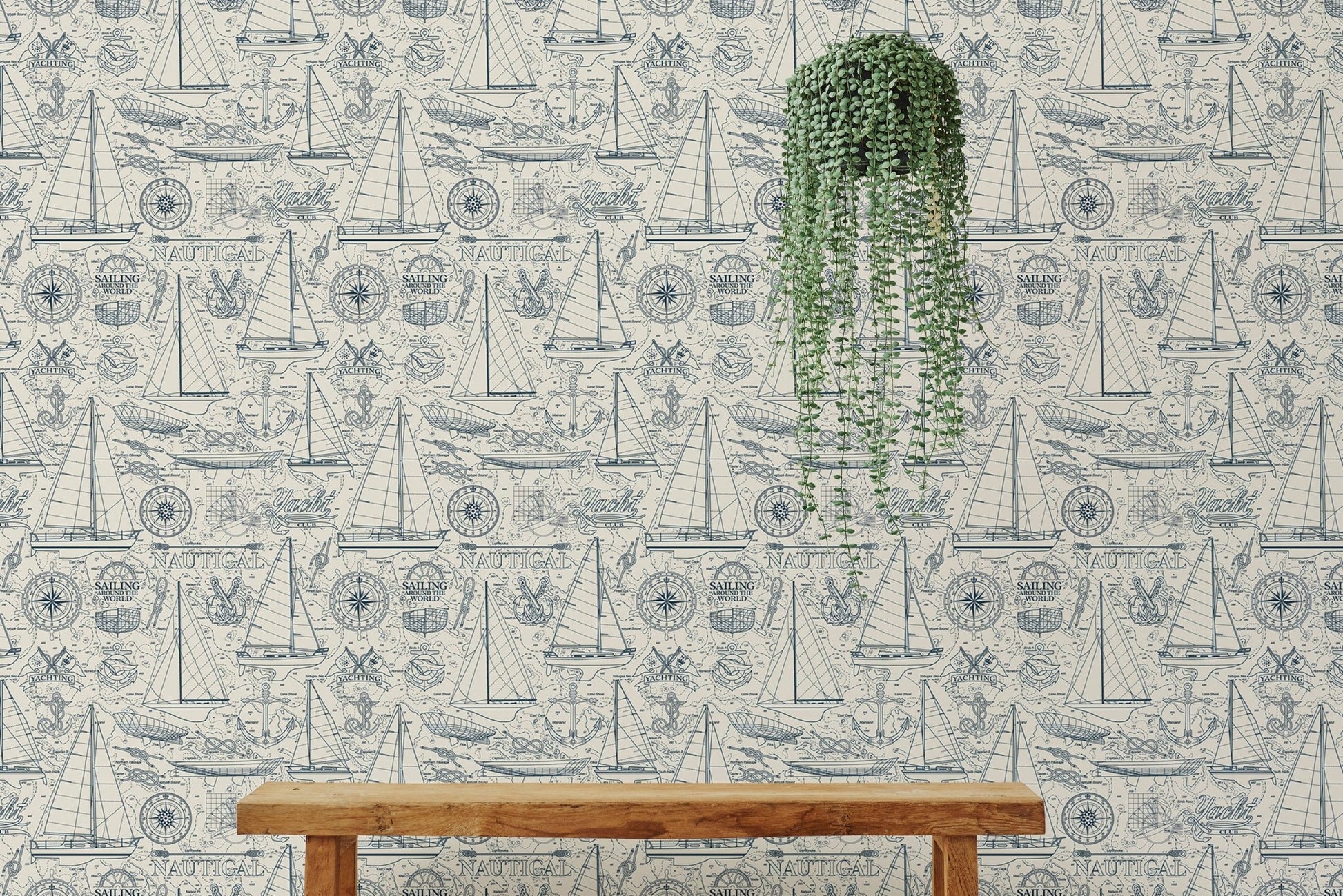 Blue compass and yacht wallpaper behind a wooden bench with hanging plants.