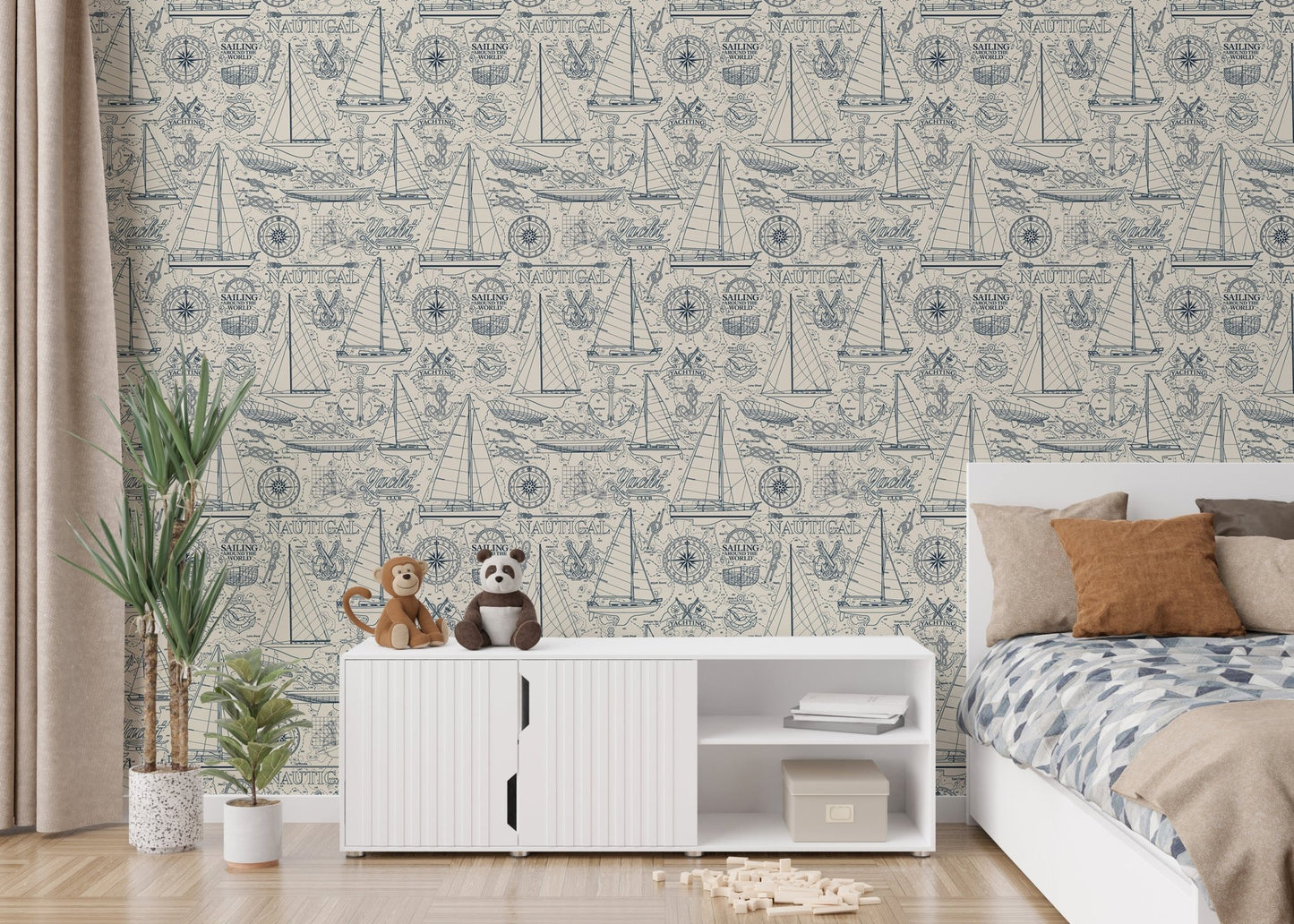 Nautical illustrations wallpaper in a kids bedroom with white furniture.