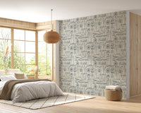 Vintage sailboat wallpaper in a sunlit bedroom with a wooden bed frame.