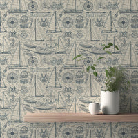 Nautical wallpaper with blue sailboats and compass on a beige textured wall.