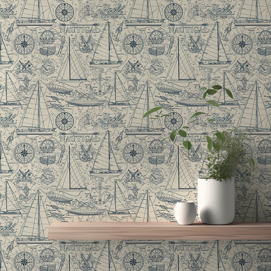 Nautical wallpaper with blue sailboats and compass on a beige textured wall.