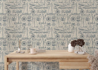 Yachting elements wallpaper behind a minimalist wooden study desk.