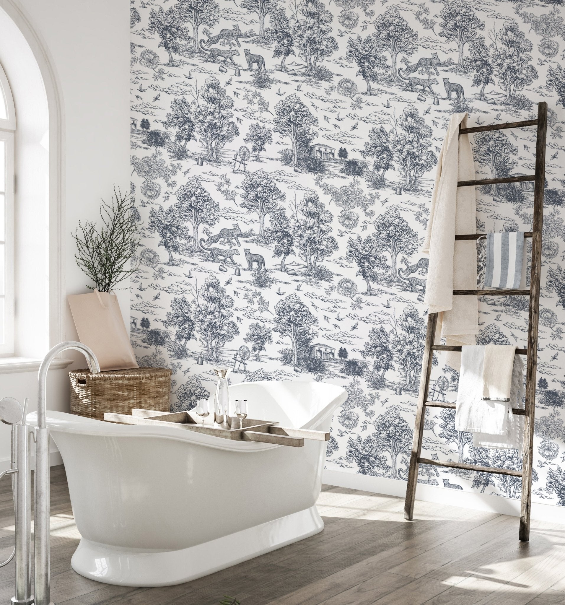 Nature inspired pattern wallpaper in a bathroom featuring a white tub and wooden ladder.