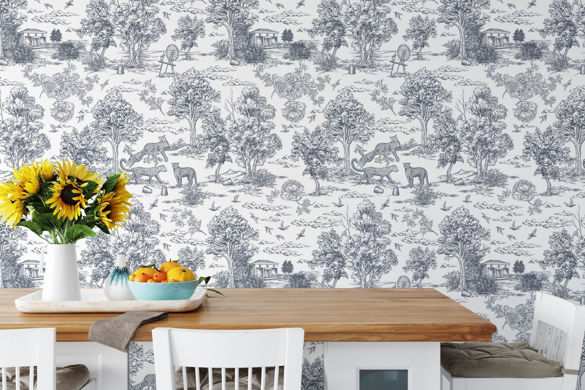 Detailed tree and leopard wallpaper in a dining area with sunflowers on the table.
