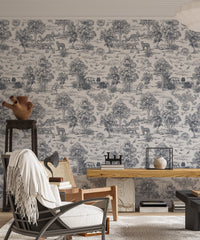 Monochrome forest pattern wallpaper in a study with a black lounge chair.