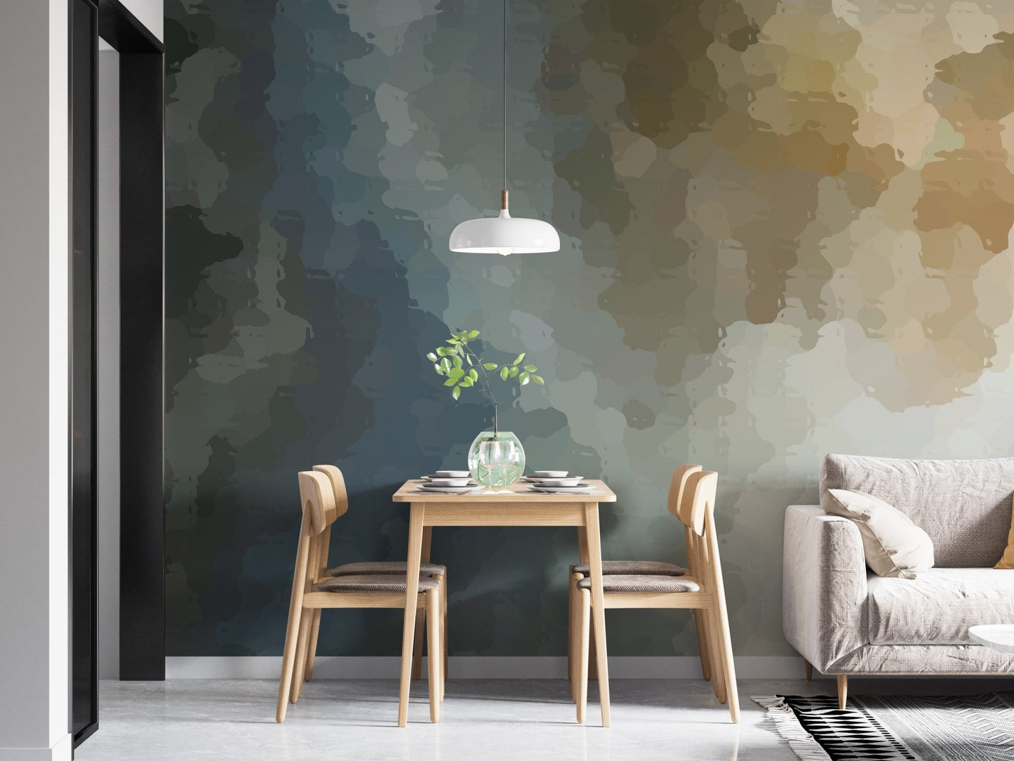 Minimalist dining area with a watercolor wall mural behind a grey sofa.