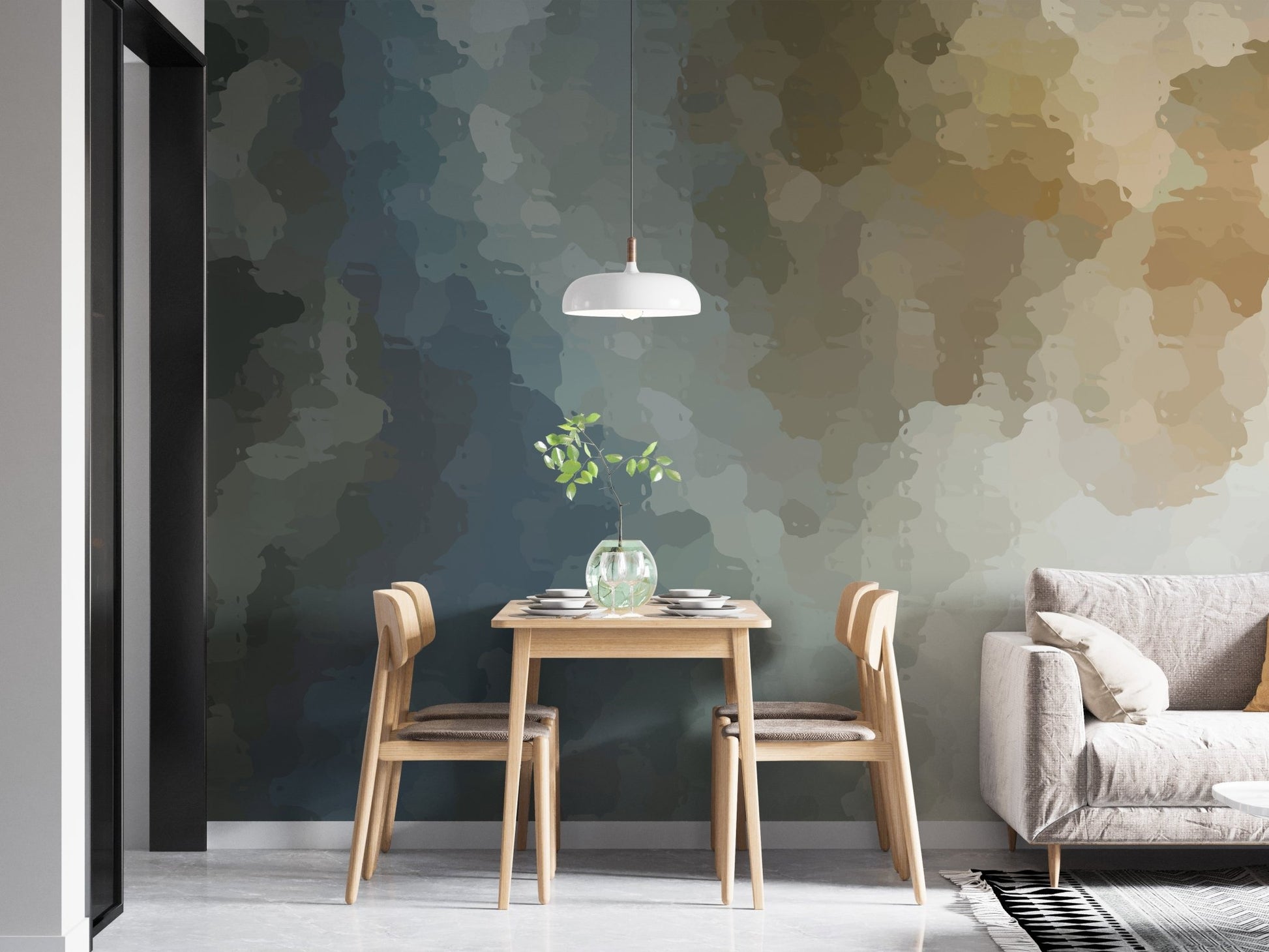 Minimalist dining area with a watercolor wall mural behind a grey sofa.