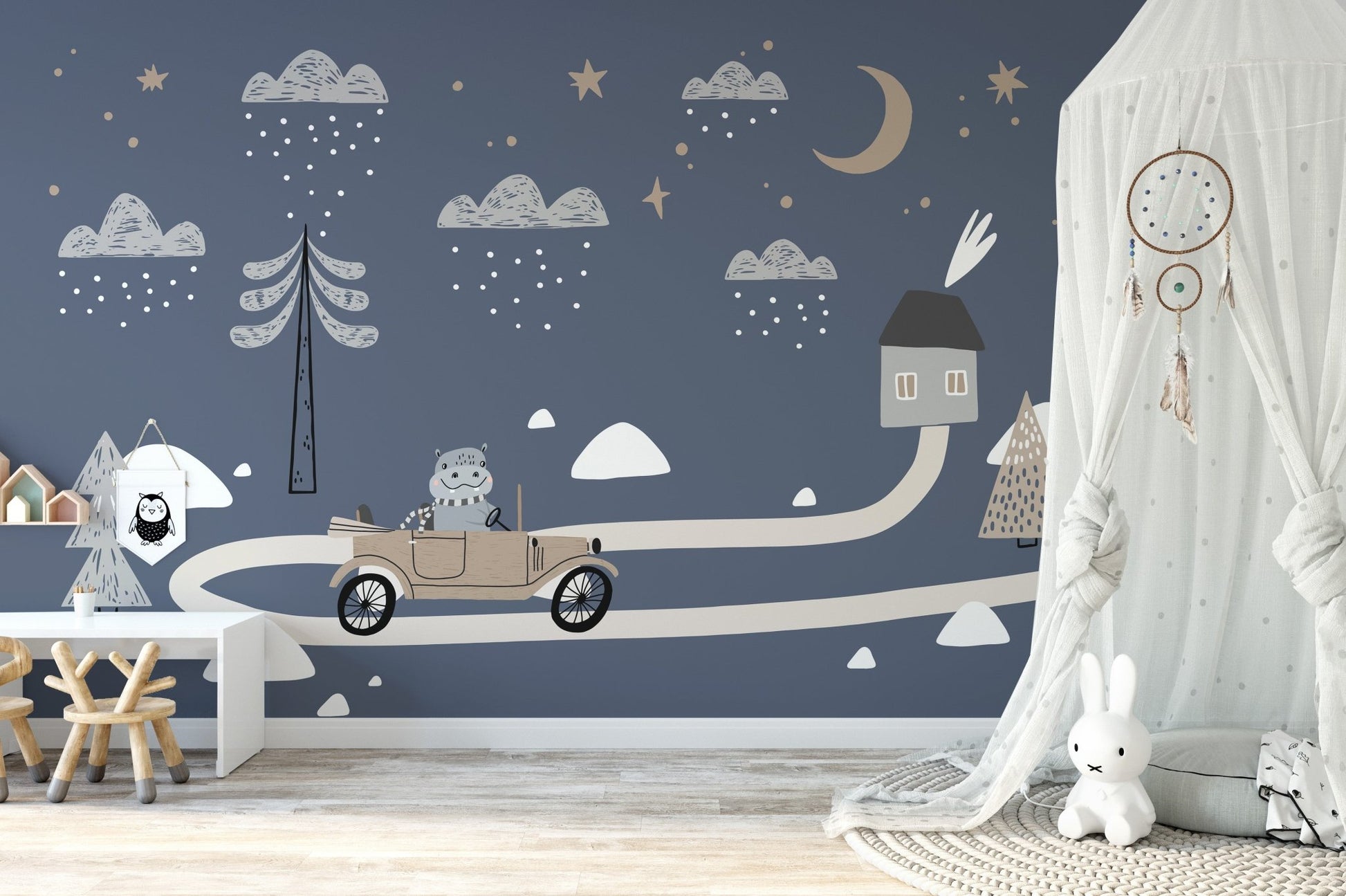 Soft nursery decor featuring a vintage car wall mural.