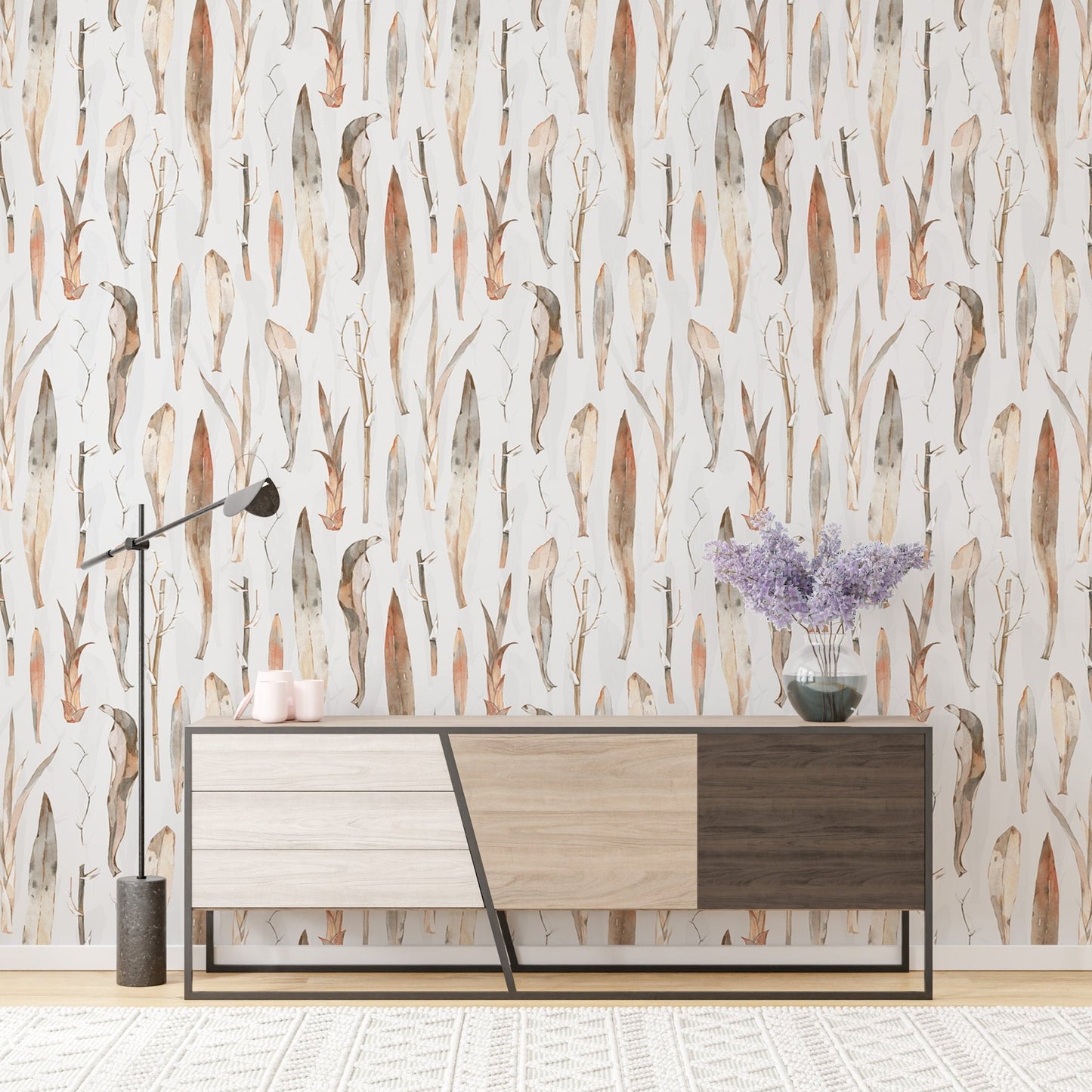 Watercolor dry leaves wallpaper behind a modern wooden sideboard.