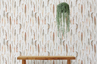 Dry leaves wallpaper styled with a hanging green plant.