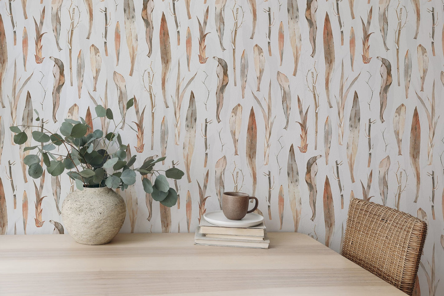 Botanical dry leaves wallpaper used as a backdrop for a minimalist work desk.