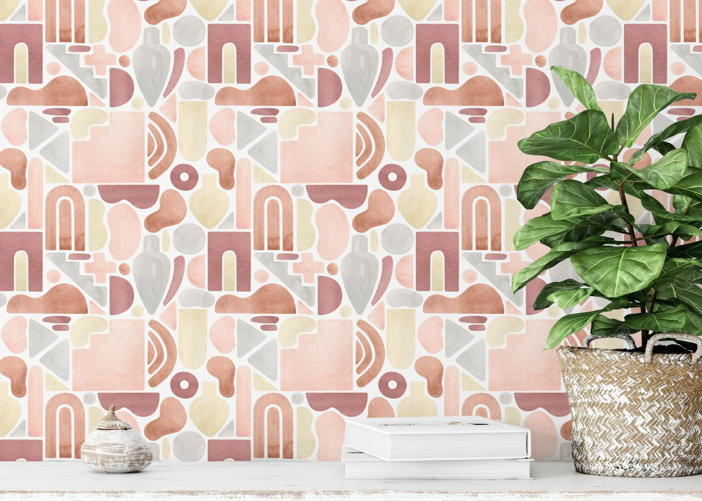 Wallpaper with pastel and ochre shapes behind a large potted fiddle leaf fig plant.