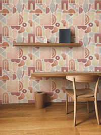 Study corner featuring terracotta boho arch wallpaper and a floating wooden shelf.