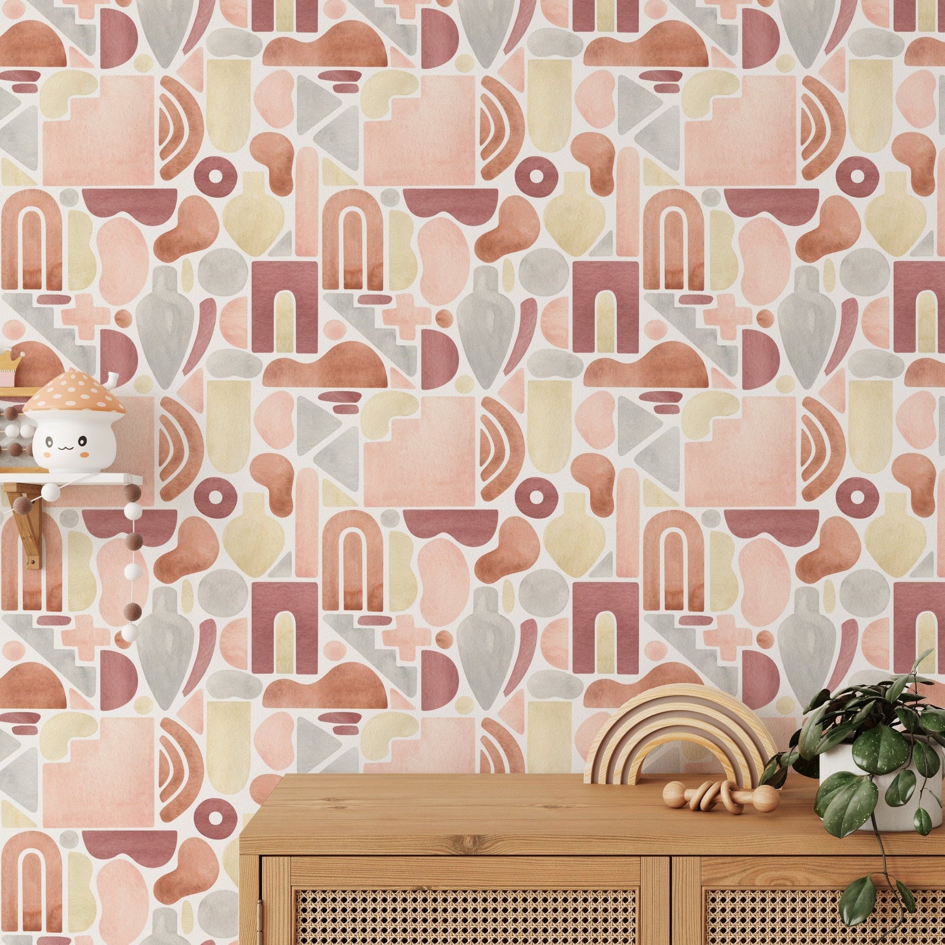 Textured abstract wallpaper with earthy tones behind a light wood sideboard and green plant.