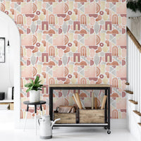 Entryway styling using boho wallpaper behind a black metal shelf and woven baskets.