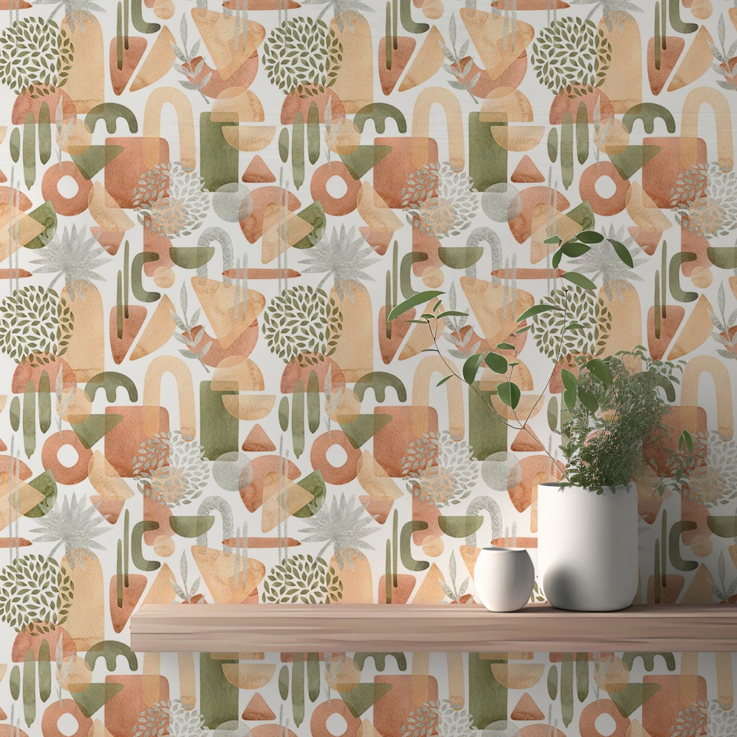 Pastel green and abstract watercolor wallpaper behind wooden desk and plat in home.