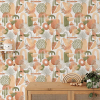 Modern sideboard decorated with plants against a watercolor abstract shapes wallpaper.