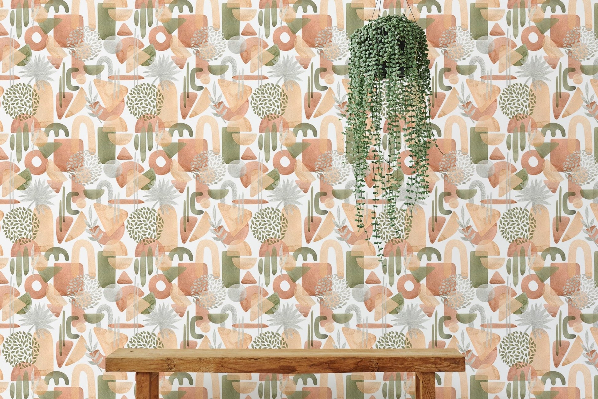 Watercolor abstract shapes wallpaper behind bench and plant.