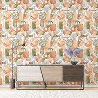 Entryway featuring warm pastel colors wallpaper behind a tri-color console.