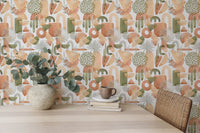 Desk area with a vase of flowers and green abstract shapes wallpaper.