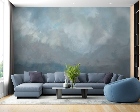 Watercolor beach wallpaper mural featuring soft blue clouds and sand.