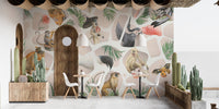 Wall mural with monkeys and tropical leaves behind a long restaurant.
