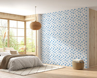 Bright bedroom with a large window and blue seamless design wallpaper.
